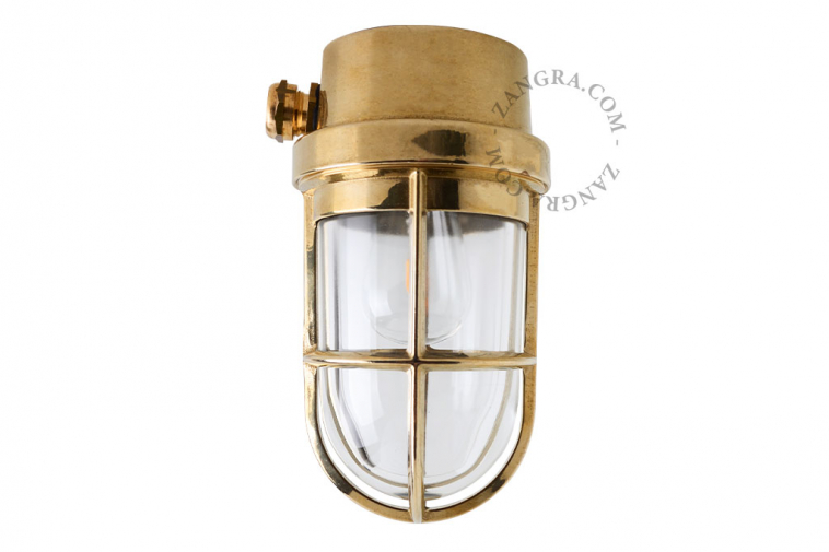 Marine-inspired brass wall or ceiling light with transparent glass.