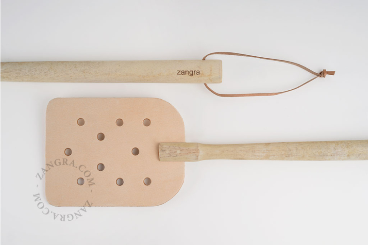 Leather fly swatter with a wooden handle.
