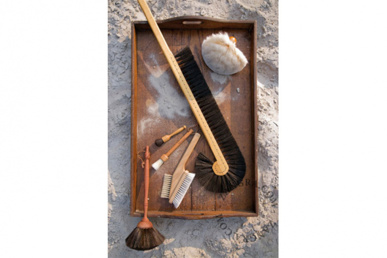 Wooden dusting brush with black or white goat hair.