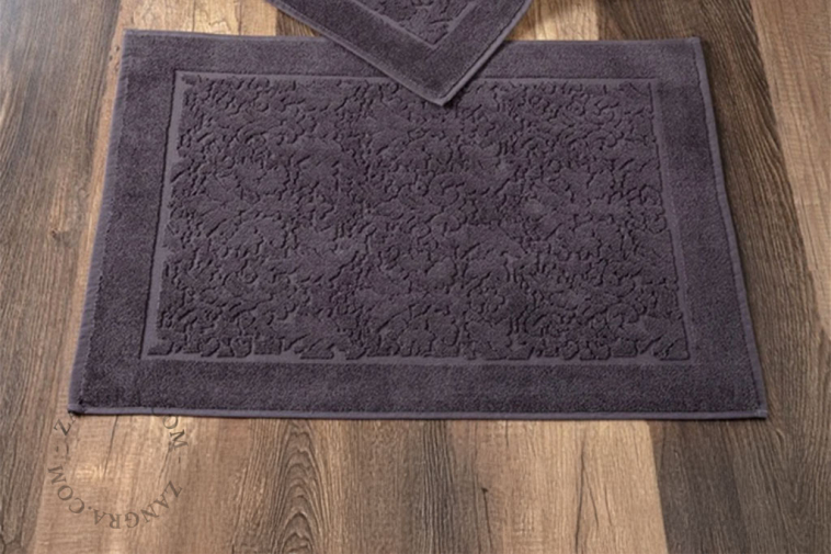 Light brown cotton bathroom mat.