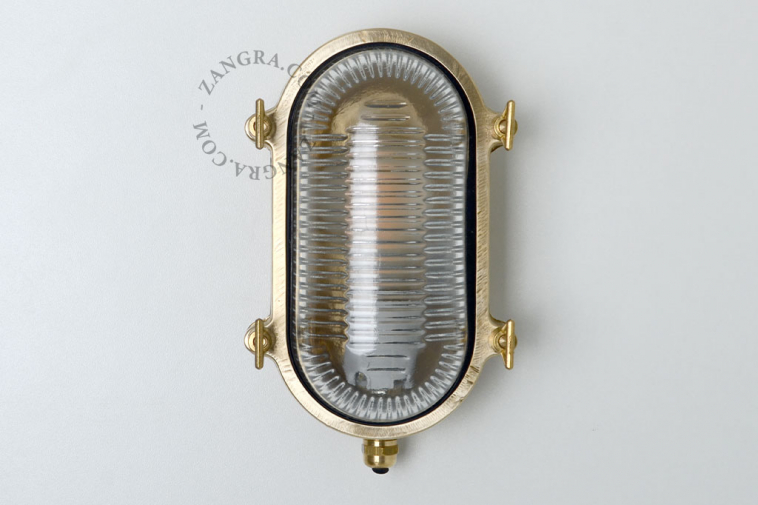 Raw brass marine wall light for outdoor use or bathroom.