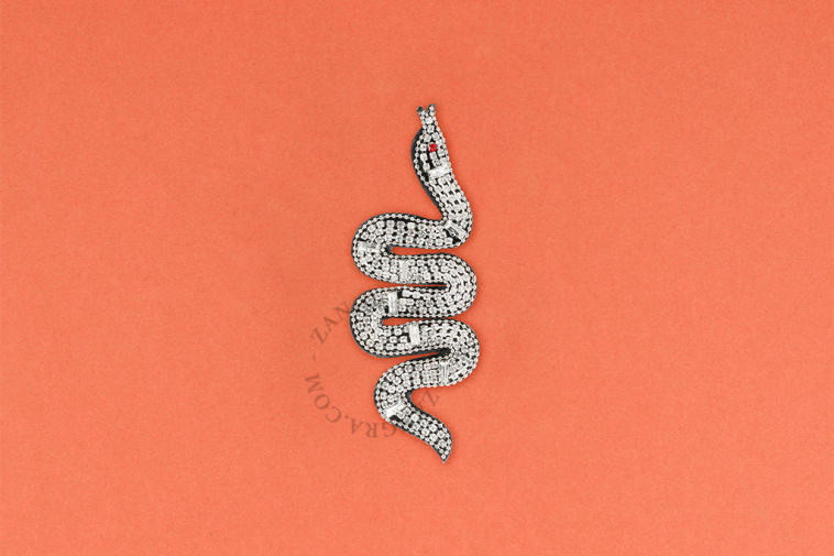 Silver snake brooch.