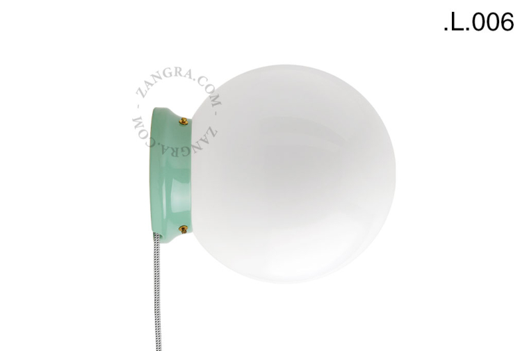 Lampe en porcelaine verte avec globe en verre.