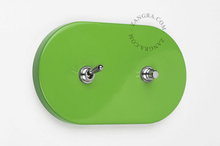 Oval green light switch and pushbutton.
