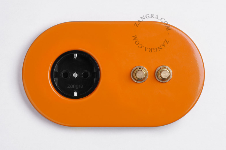 2 gold push buttons on orange integrated outlet