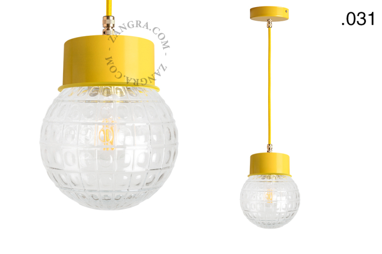 Yellow pendant light with glass shade.