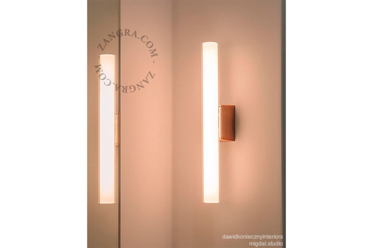 opal tubular light bulb on a copper lamp holder