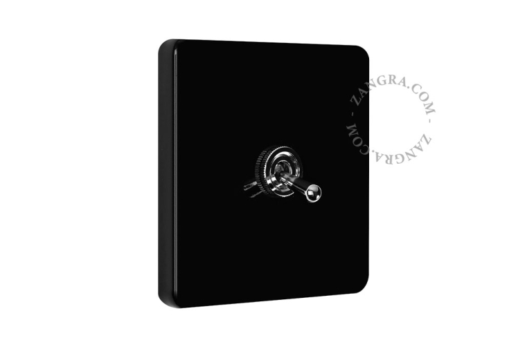 Vierkante lichtschakelaar in zwart porselein met tuimelschakelaar.