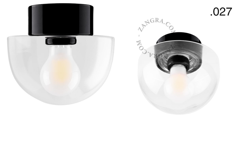 Zwarte porseleinen lamp met glazen schroefkap.