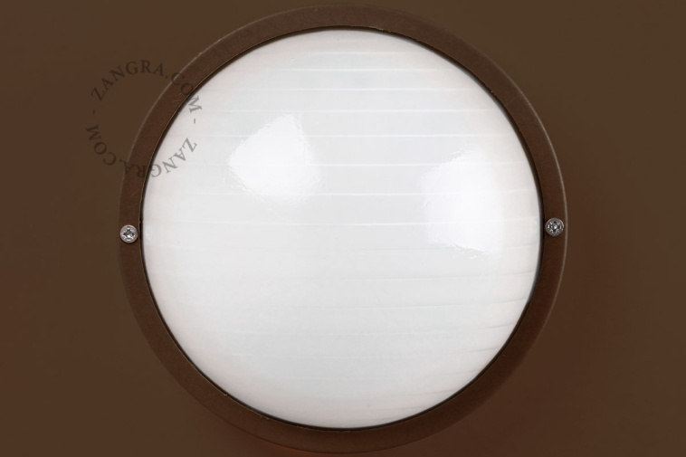 Round, brown bulkhead light.