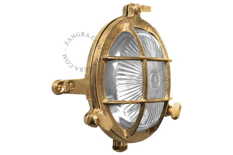 Lampe hublot ronde en laiton avec grillage.