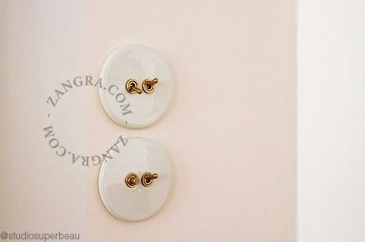 Round white porcelain light switch.