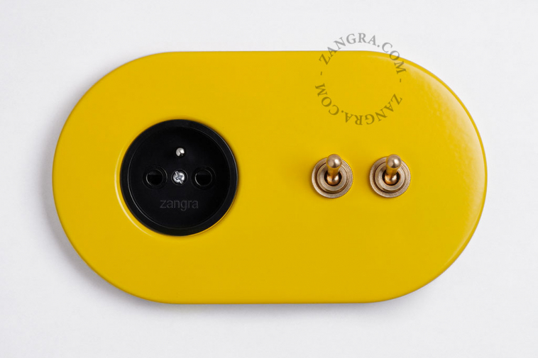 yellow flush mount outlet & two-way or simple switch – double raw brass toggle