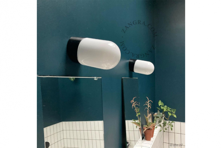 black porcelain wall light with glass globe for bathroom or outdoor use