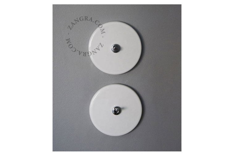 Round white porcelain light switch.