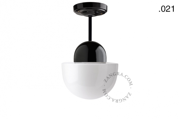 Black porcelain ceiling light with glass shade.