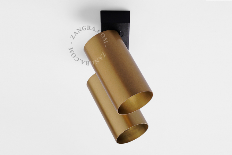 Double surface mounted adjustable spotlight in brass.