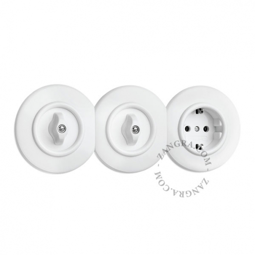 White bakelite central faceplate for outlets and dimmers.