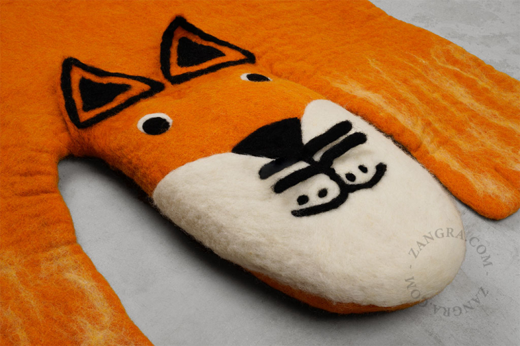 Fox-shaped felt rug.
