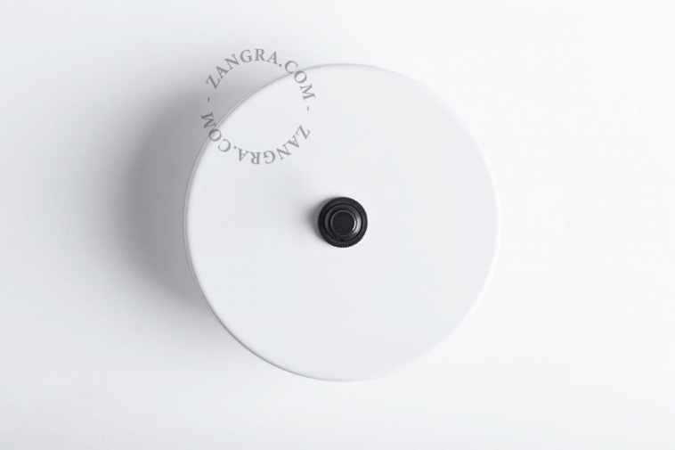 Round white light switch with black pushbutton