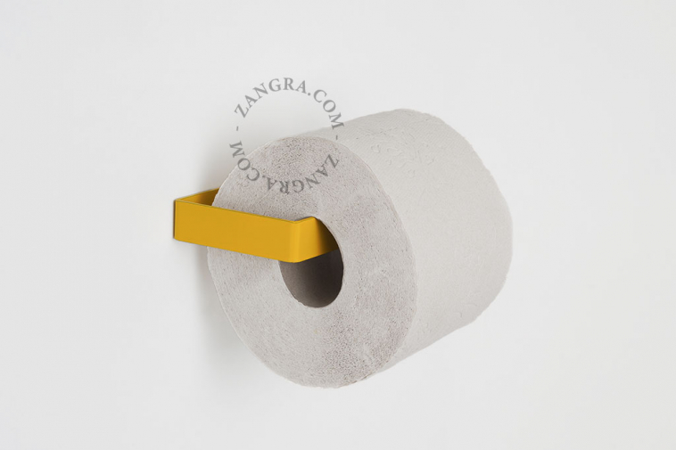Yellow metal toilet paper holder.