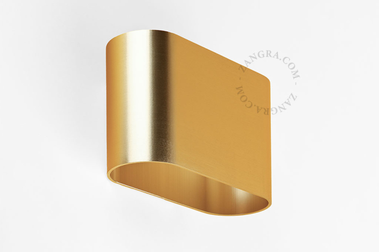 Applique bidirectionnelle dorée.