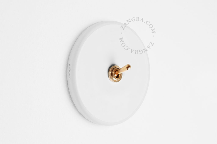 Round white porcelain light switch.