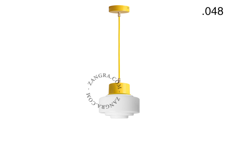 Yellow pendant light with glass shade.