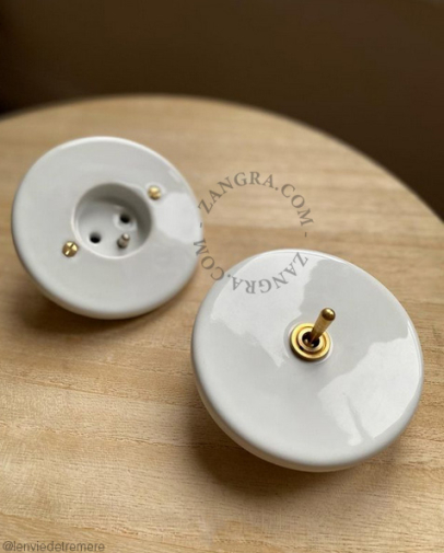 Round white porcelain light switch.