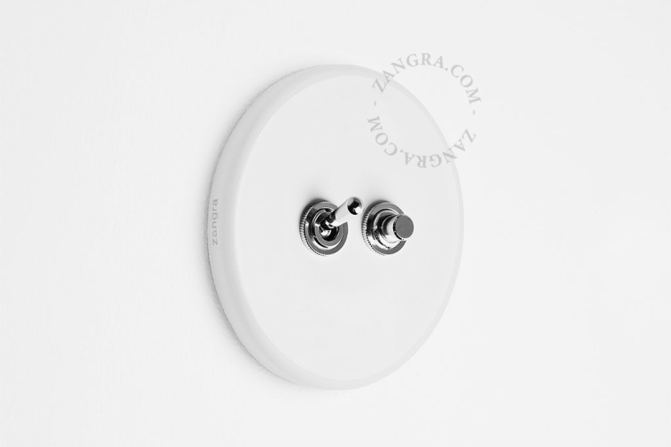 Round white porcelain light switch.