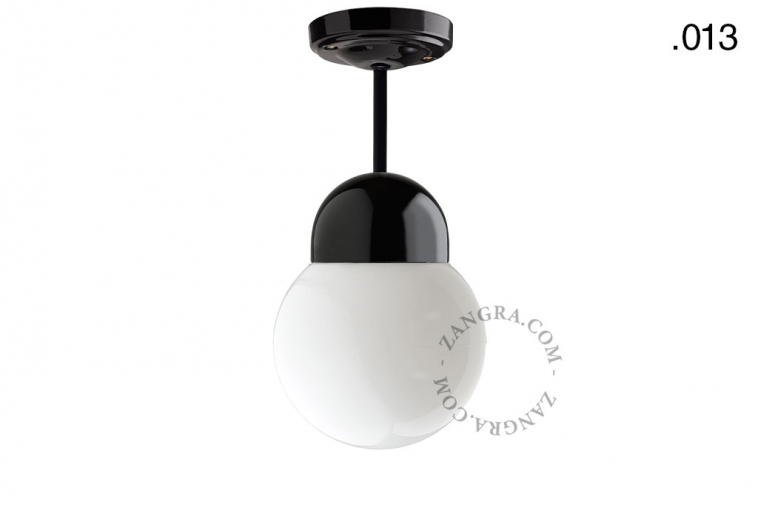 Black porcelain ceiling light with glass shade.