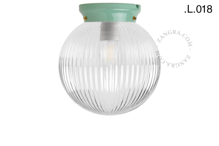 Green porcelain Art Deco light with glass shade.