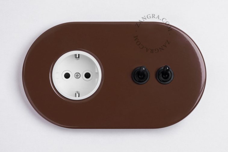 Brown outlet with double toggle switch.