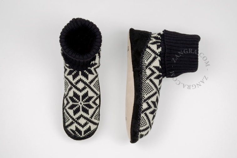 Black knitted slippers with leather sole.