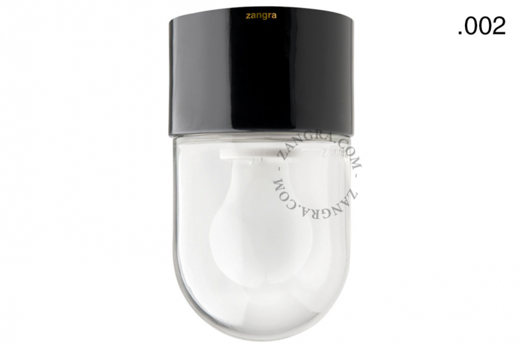 Black porcelain light fixture with glass globe.