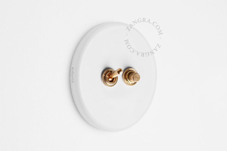 Round white porcelain light switch.