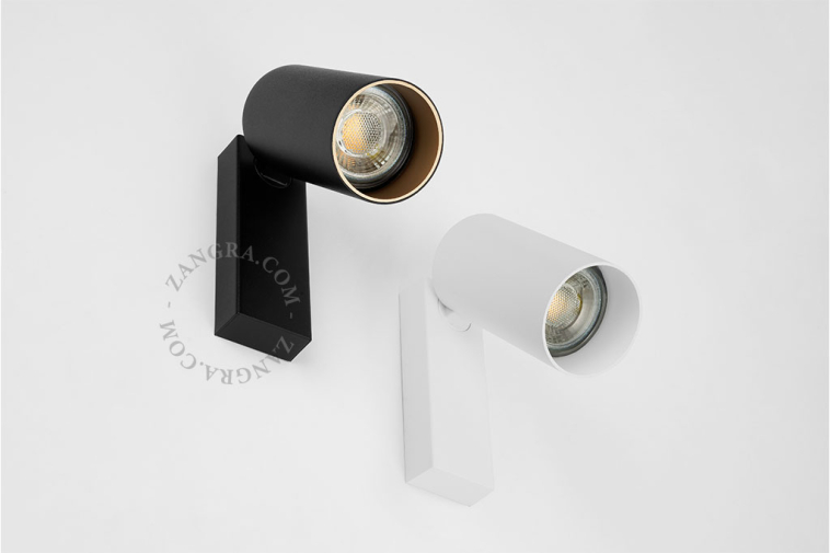 Cylinder-shaped surface spot with light switch in white color.