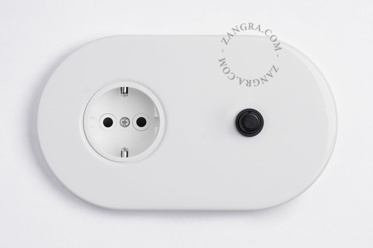 White flush mount outlet & switch with a black pushbutton.