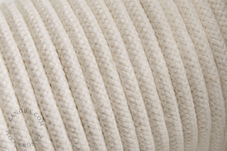 Electrical cable covered in ivory cotton.