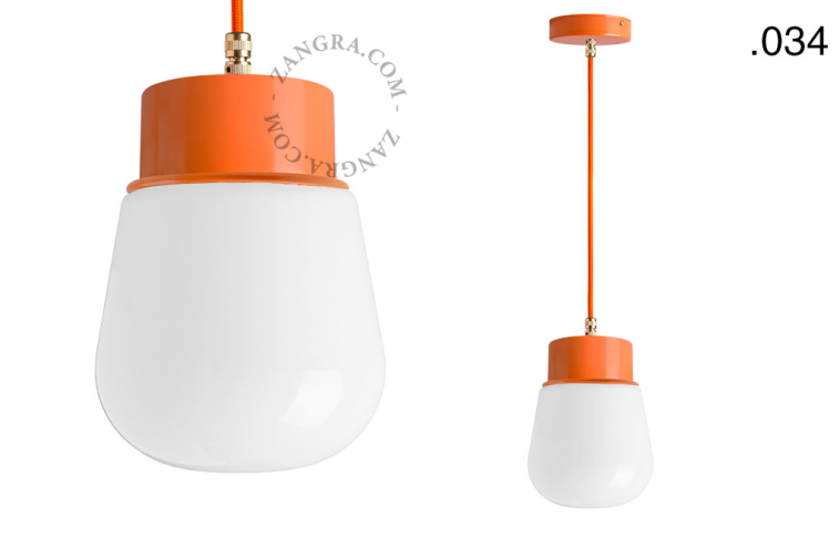 Orange pendant light with glass shade.