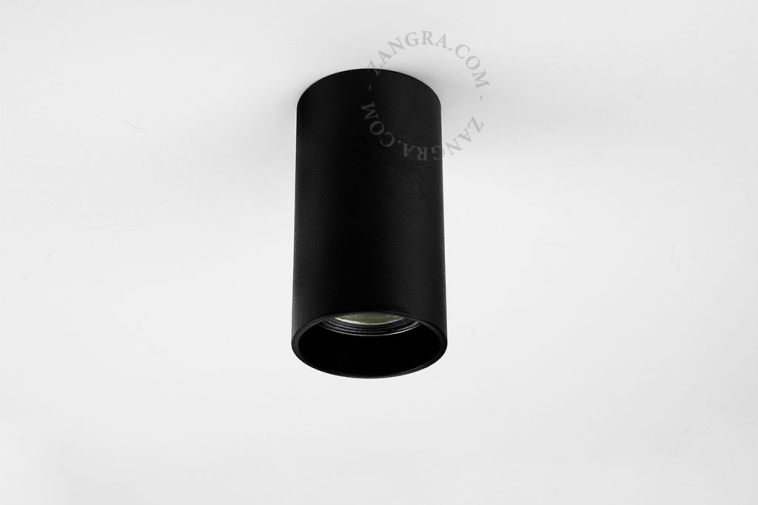 Surface-mounted cylindrical spotlights.