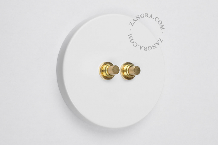 Double raw brass pushbutton light switch