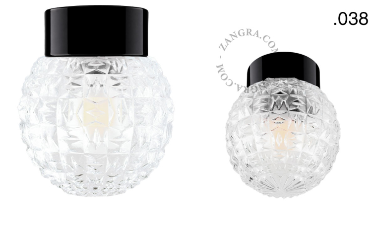 Zwarte porseleinen lamp met glazen schroefkap.