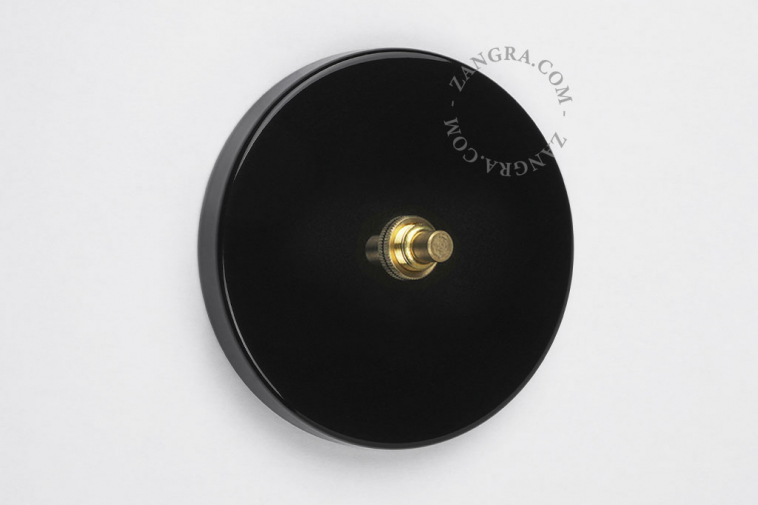 interrupteur poussoir noir avec bouton-poussoir en laiton brut couleur or
