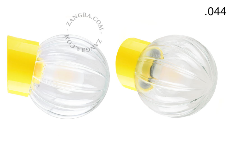 Yellow porcelain wall light with glass lampshade.