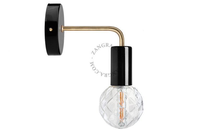 black wall light with brass arm