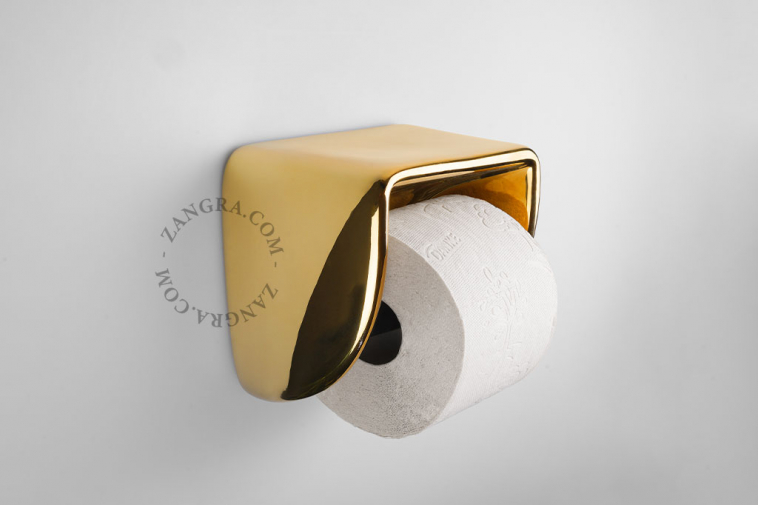 Golden porcelain toilet paper holder.