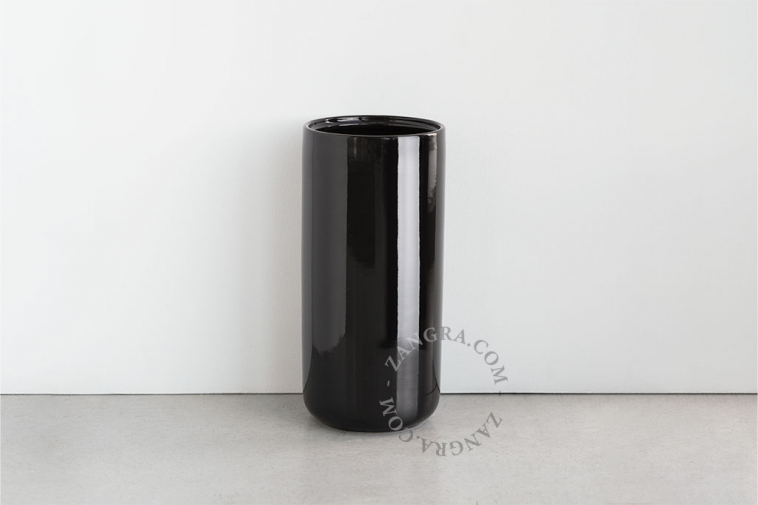 Black porcelain toilet brush holder with wooden brush.