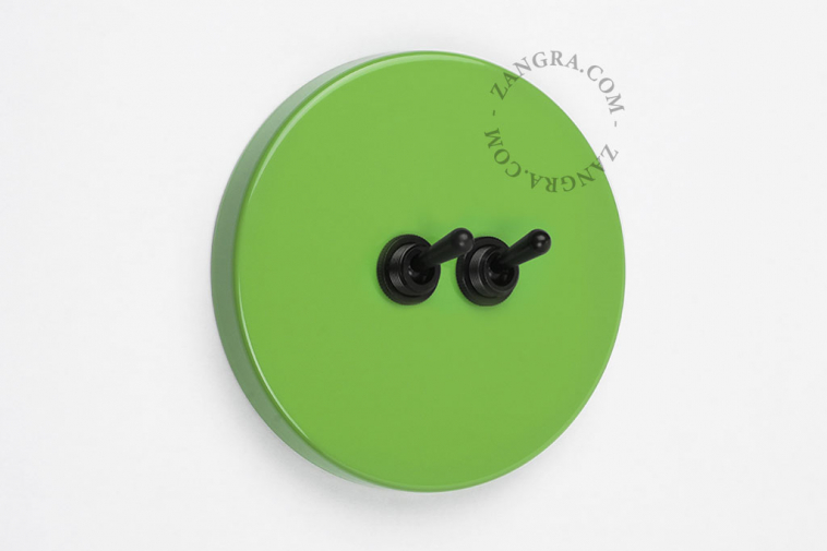 Round green double light switch.