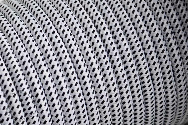White fabric cable with black dots.